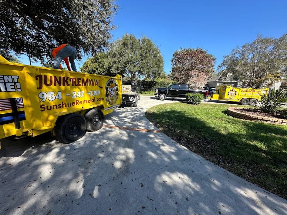 Yellow dump trailer on driveway